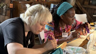 two students working at queen grafting tables