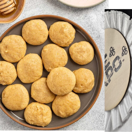 brown plate with dozen small cookies and honey with dropper upper left corner