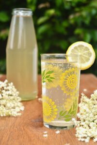 Bottle and glass filled with elderflower cordial