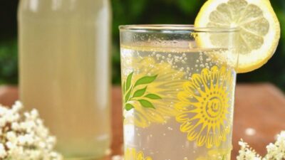 Bottle and glass filled with elderflower cordial