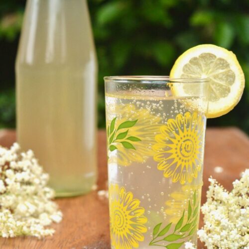 Bottle and glass filled with elderflower cordial